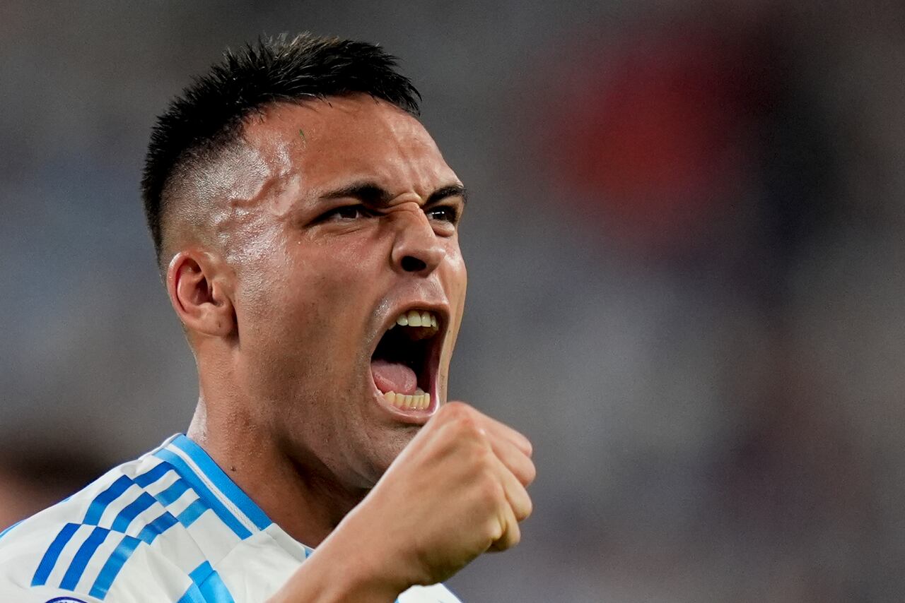 Argentina's Lautaro Martinez celebrates scoring his side's opening goal against Chile during a Copa America Group A soccer match in East Rutherford, N.J., Tuesday, June 25, 2024. (AP Photo/Julia Nikhinson)