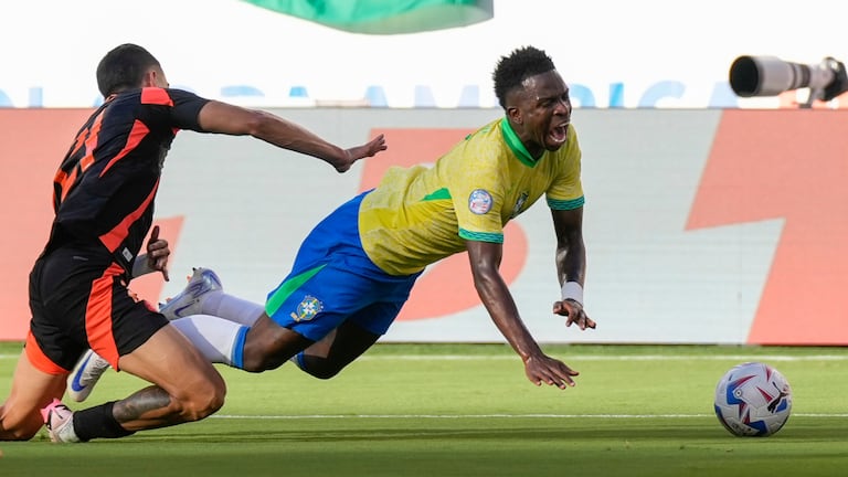 Brazil's Vinicius Junior falls as he is tackled by Colombia's Daniel Munoz during a Copa America Group D soccer match in Santa Clara, Calif., Tuesday, July 2, 2024. (AP Photo/Tony Avelar)