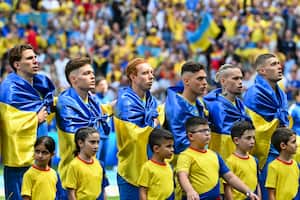 Ukraine's players line up prior to the UEFA Euro 2024 Group E football match between Romania and Ukraine at the Munich Football Arena in Munich on June 17, 2024. (Photo by Miguel MEDINA / AFP)