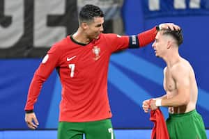 Portugal's forward #07 Cristiano Ronaldo (L) congratulates Portugal's forward #26 Francisco Conceicao after he scored his team's second goal during the UEFA Euro 2024 Group F football match between Portugal and the Czech Republic at the Leipzig Stadium in Leipzig on June 18, 2024. (Photo by Christophe SIMON / AFP)