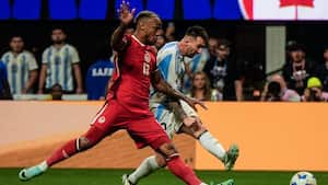 Canada's Moise Bombito (15) moves with Argentina's Lionel Messi in the second half during a Copa America Group A soccer match in Atlanta, Thursday, June 20, 2024. Canadian soccer player Moise Bombito had racist messages directed at him on social media after he made a tackle on Lionel Messi during a 2-0 Copa America loss to Argentina. The Canadian National Team issued a statement on social media late Thursday night about the messages without mentioning Bombito by name.(AP Photo/Mike Stewart)
