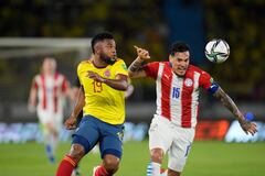 Colombia's Miguel Angel Borja, left, fights for the ball with Paraguay's Gustavo Gomez during a qualifying soccer match for the FIFA World Cup Qatar 2022, at Metropolitano stadium in Barranquilla, Colombia, Tuesday, Nov. 16, 2021. (AP Photo/Fernando Vergara)