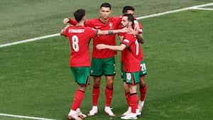 Portugal's midfielder #08 Bruno Fernandes (L) celebrates with teammates after scoring his team's third goal during the UEFA Euro 2024 Group F football match between Turkey and Portugal at the BVB Stadion in Dortmund on June 22, 2024. (Photo by KENZO TRIBOUILLARD / AFP)