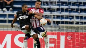 Junior Santos of Brazil's Botafogo, left, and Howell Mena of Colombia's Junior battle for the ball during a Copa Libertadores Group D soccer match at the Metropolitan stadium in Barranquilla, Colombia, Tuesday, May 28, 2024. (AP Photo/Fernando Vergara)
