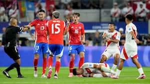 Peru's Carlos Zambrano grimaces in pain on the ground during a Copa America Group A soccer match against Chile in Arlington, Texas, Friday, June 21, 2024. (AP Photo/Julio Cortez)