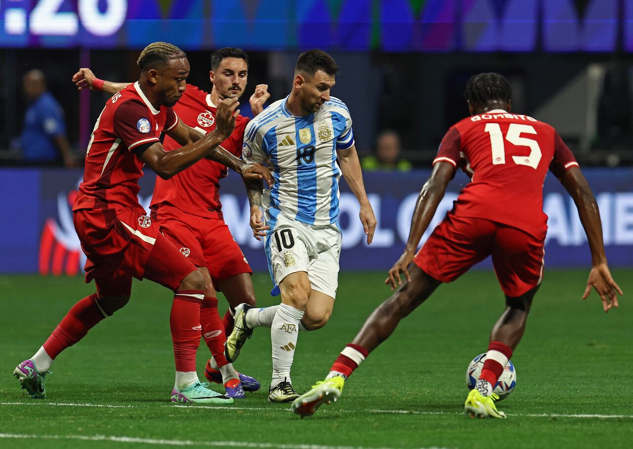 Soccer Football - Copa America 2024 - Group A - Argentina v Canada - Mercedes-Benz Stadium, Atlanta, Georgia, United States - June 20, 2024 Argentina's Lionel Messi in action with Canada's Moise Bombito REUTERS/Agustin Marcarian
