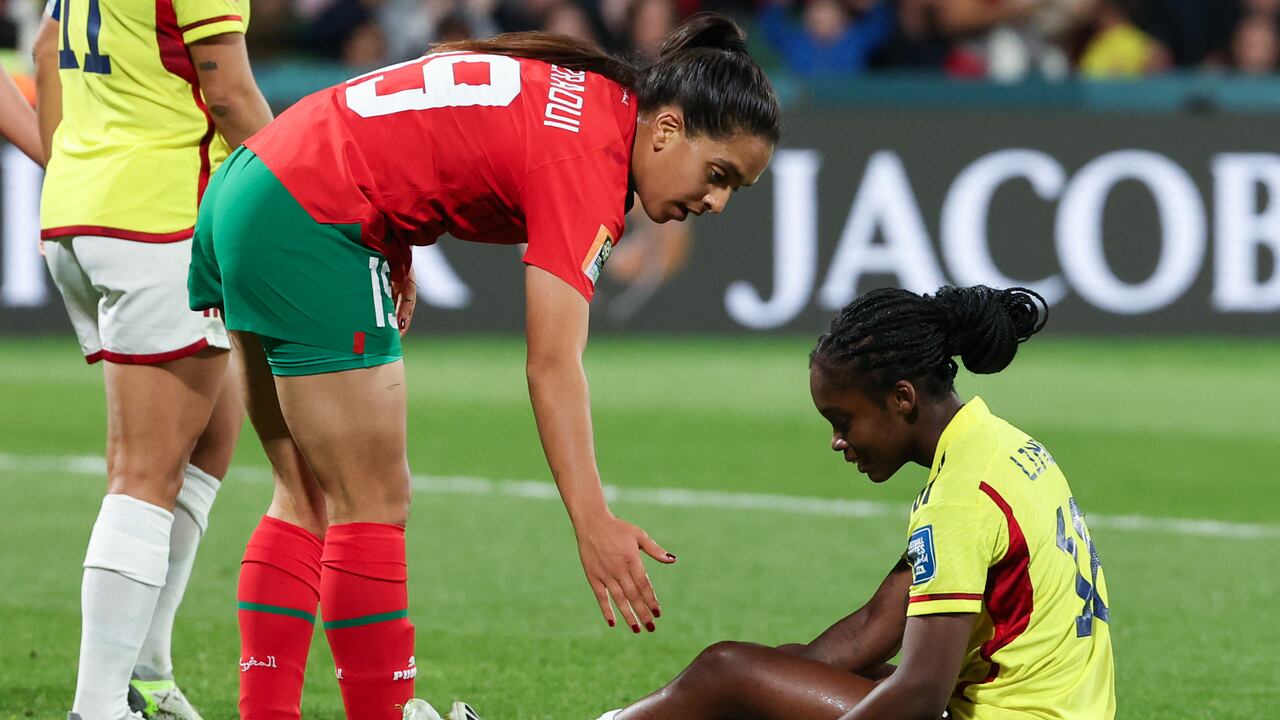 Morocco's forward #19 Sakina Diki (L) helps Colombia's forward #18 Linda Caicedo up after a challenge during the Australia and New Zealand 2023 Women's World Cup Group H football match between Morocco and Colombia at Perth Rectangular Stadium in Perth on August 3, 2023. (Photo by Colin MURTY / AFP)