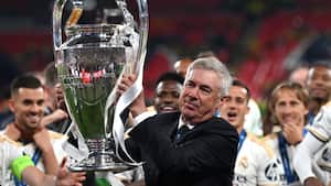 Real Madrid's Italian coach Carlo Ancelotti lifts the trophy to celebrate the victory at the end of the UEFA Champions League final football match between Borussia Dortmund and Real Madrid, at Wembley stadium, in London, on June 1, 2024. (Photo by Glyn KIRK / AFP)
