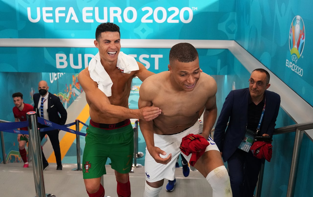 BUDAPEST, HUNGARY - JUNE 23: Cristiano Ronaldo of Portugal interacts with Kylian Mbappe of France in the tunnel following the UEFA Euro 2020 Championship Group F match between Portugal and France at Puskas Arena on June 23, 2021 in Budapest, Hungary. (Photo by Angel Martinez - UEFA/UEFA via Getty Images)